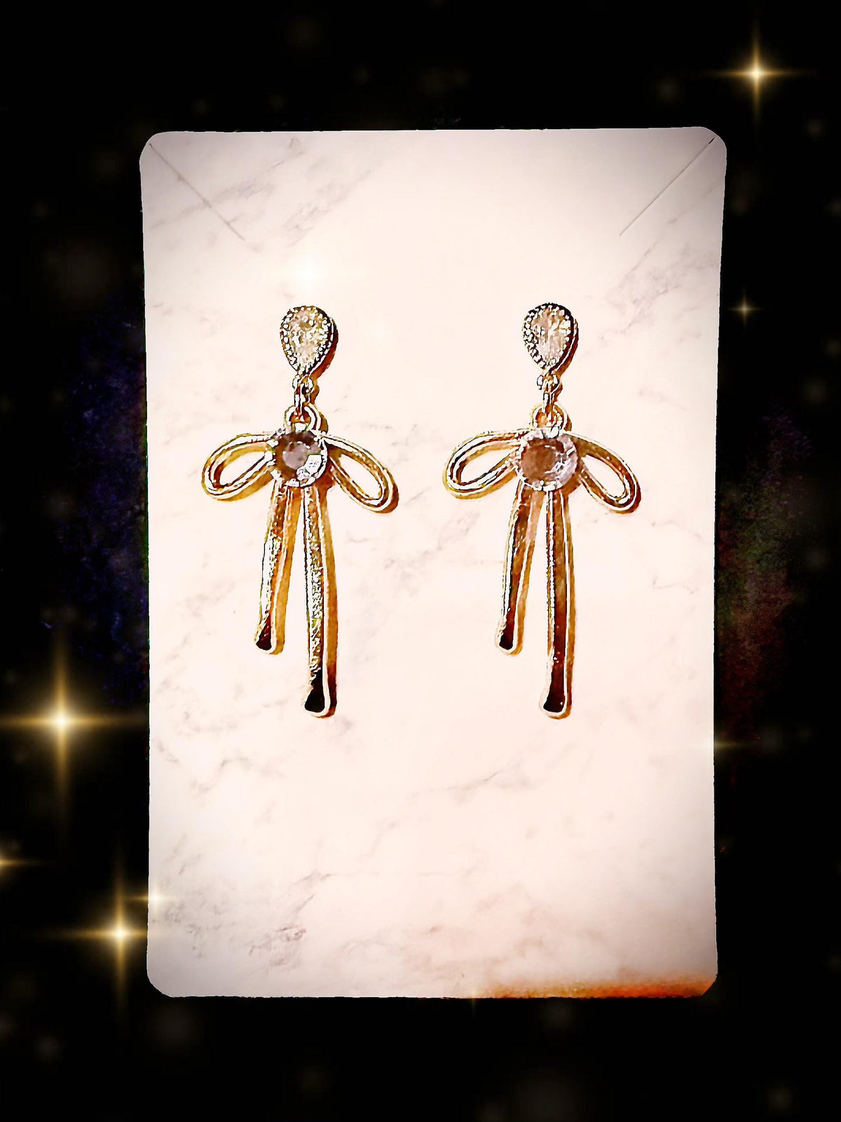 Gold tone bow earrings with blue Australian crystal centers